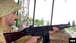 Pakistani troop at a checkpoint in Pakistan's restive Bajaur tribal area near the Afghan border in August