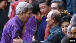 U.S. Secretary of State John Kerry (left) speaks to Russian President Vladimir Putin at the APEC summit