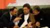 FILE: Abdullah Abdullah (R) and Atta Mohammad Noor (L) speak with Abdullah's deputy Mohammad Mohaqiq (C) during a political gathering in Kabul in 2013.