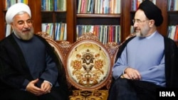 Iranian President-elect Hassan Rohani (left) meets with ex-President Mohammad Khatami at his home in Tehran in June 2013.