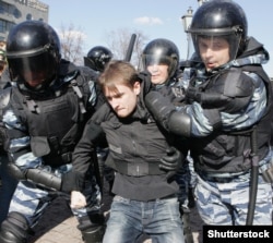 Police detain a young antigovernment protester at Pushkin Square on March 26.