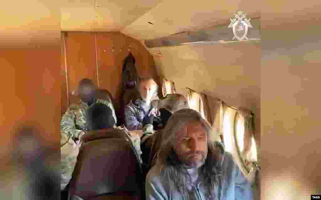 Vissarion is transported by plane after being detained along with two senior members of his organization by Federal Security Service (FSB) agents on September 22. 