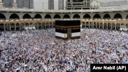 Muslim pilgrims walk around the Kaaba, the cubic building at the Grand Mosque, ahead of the Hajj pilgrimage in the holy city of Mecca on August 8