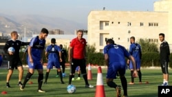 Iran's national football team Head Coach Carlos Queiroz, center, conducts a training session a day ahead of a Group A match against Syria during the 2018 FIFA World Cup Russia Qualifier in Tehran, Iran, Monday, Sept. 4, 2017. Millions of Syrians may final