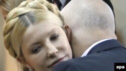 Yulia Tymoshenko is embraced by her husband, Oleksandr, during her verdict hearing in Kyiv on October 11.