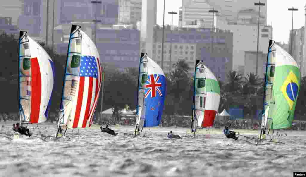 An international lineup of sails at the start of the women&#39;s skiff sailing event.&nbsp;