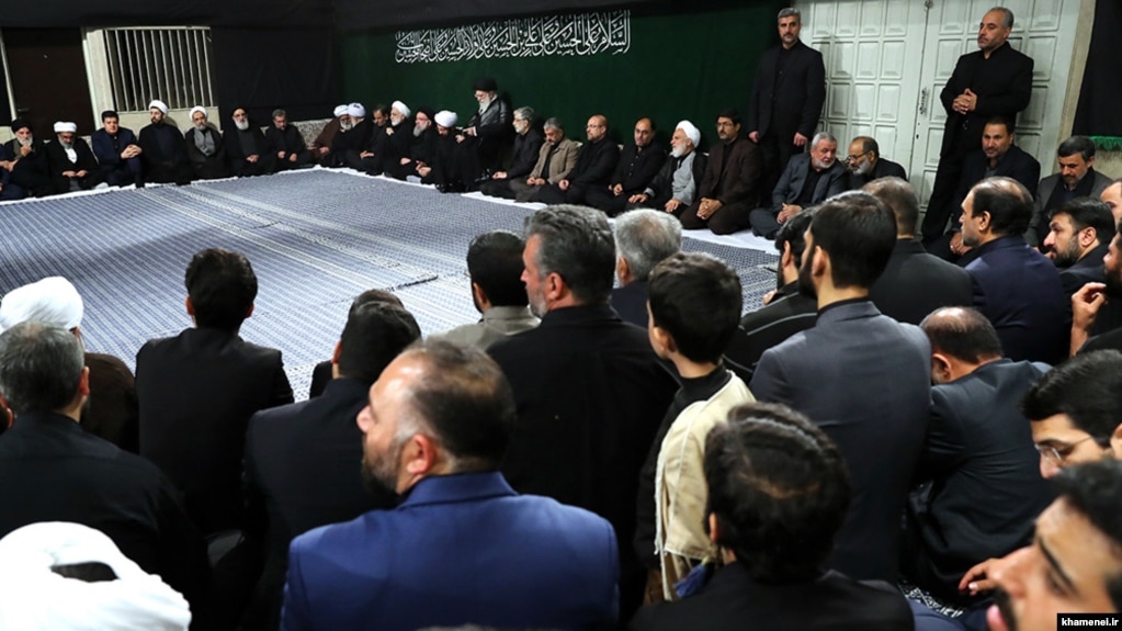 Former president Mahmoud Ahmadinejad sitting at the very end of the top row (to the right of the photo) in mourning ceremony chaired by Supreme leader, Khamenei.