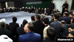 Former president Mahmoud Ahmadinejad sitting at the very end of the top row (to the right of the photo) in mourning ceremony chaired by Supreme leader, Khamenei.