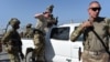 FILE: U.S. soldiers leave a truck inside an Afghan military base during fighting between Taliban militants and Afghan security forces in the northeastern city of Kunduz in 2015.
