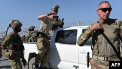 FILE: U.S. soldiers leave a truck inside an Afghan military base during fighting between Taliban militants and Afghan security forces in the northeastern city of Kunduz in 2015.