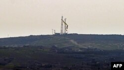 The flag of the Syrian Kurdish People's Protection Units (YPG) flies in the Syrian town of Kobani of January 26.