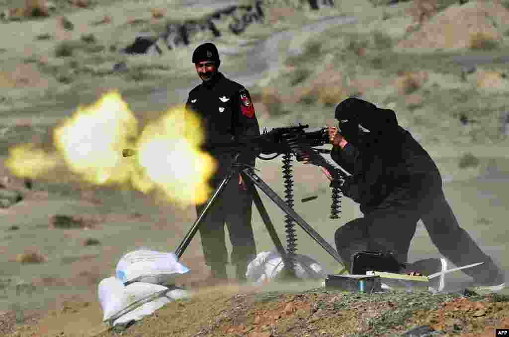 A Pakistani policewoman fires a heavy machine gun during a special training course in Nowshera, a district in Khyber Pakhtunkhwa Province, on February 11. (AFP/A Majeed)