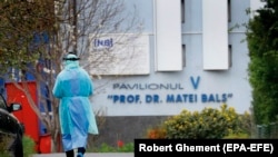 Medic în costum de protecție în fața Spitalului Matei Balș
