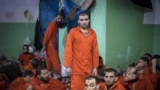 Syria - Men, suspected of being affiliated with the Islamic State (IS) group, gather in a prison cell in the northeastern Syrian city of Hasakeh on October 26, 2019. - Kurdish sources say around 12,000 IS fighters including Syrians, Iraqis as well as fore