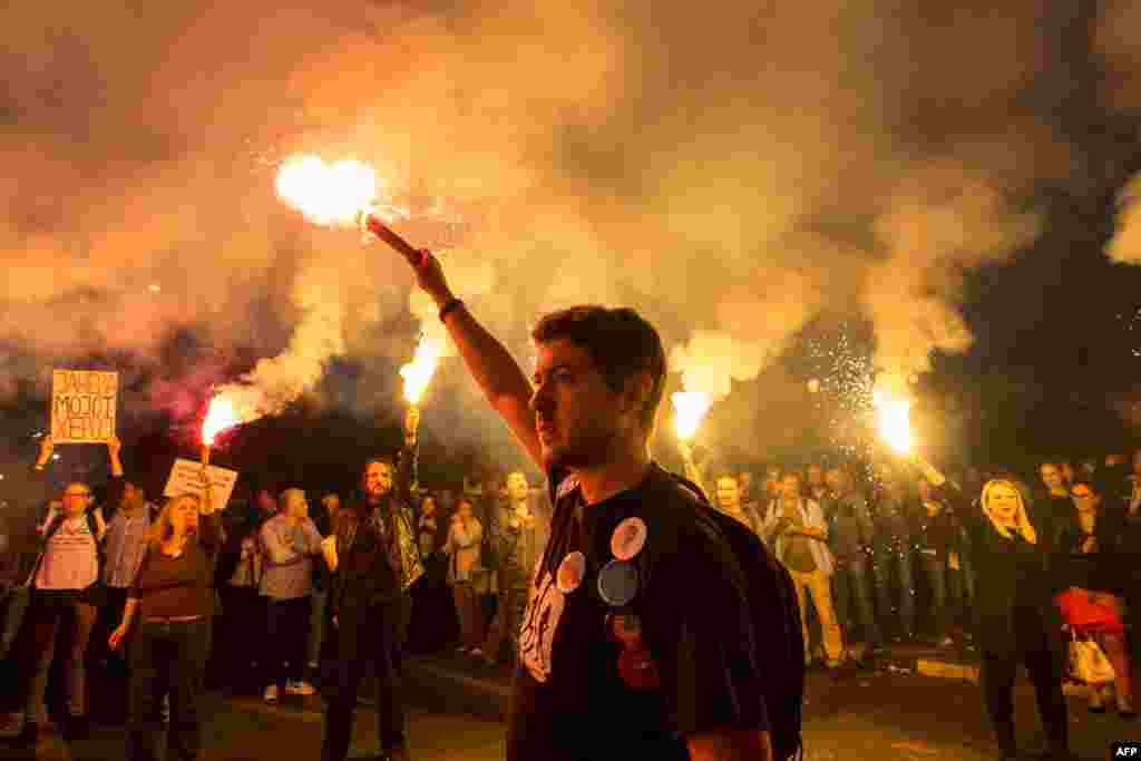 Protesters light flares outside the Macedonian parliament during an antigovernment protest in Skopje. (AFP/Robert Atanasovski)