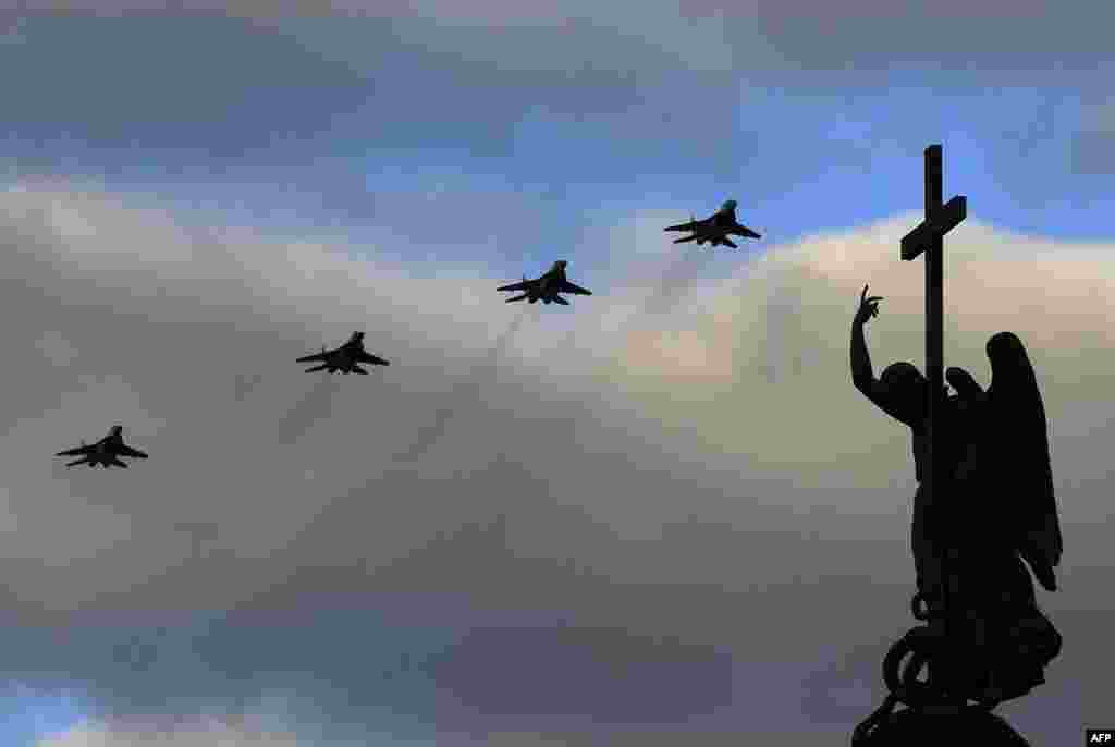 Russian military aircraft fly over St. Petersburg's Dvortsovaya Square during a rehearsal for the Victory Day military parade, on May 3. (AFP/Olga Maltseva)