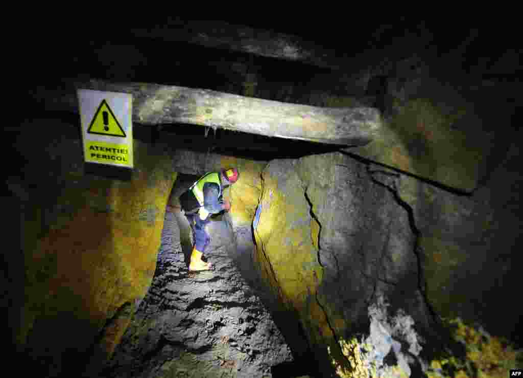 The Rosia Montana site has been used for gold mining for centuries. Here an employee of Gabriel Resources&#39; local subsidiary stands inside a mineshaft from Roman times. (AFP/Daniel Mihailescu)