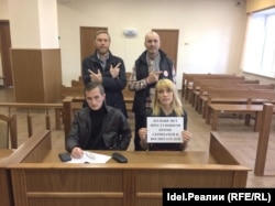 Russian schoolteacher Yelena Blinova (bottom right) landed in hot water when she signaled support for an opposition blogger. (file photo)