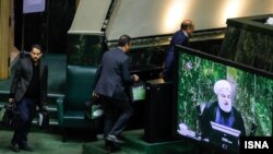 Officials carrying copies of Iran's next year budget in the parliament as President Hassan Rouahni makes his speech. December 8, 2019