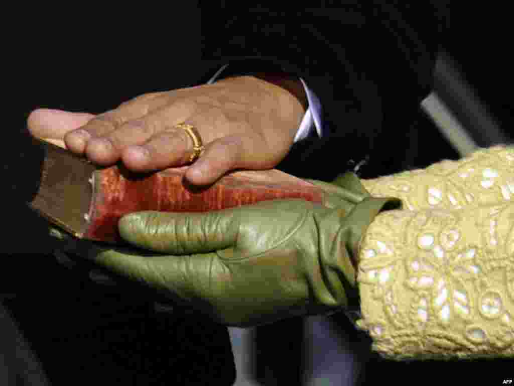 Barack Obama's hand lies on a bible as he is sworn in as the 44th US president by Supreme Court Chief Justice John Roberts in front of the Capitol in Washington on January 20, 2009. (AFP) 