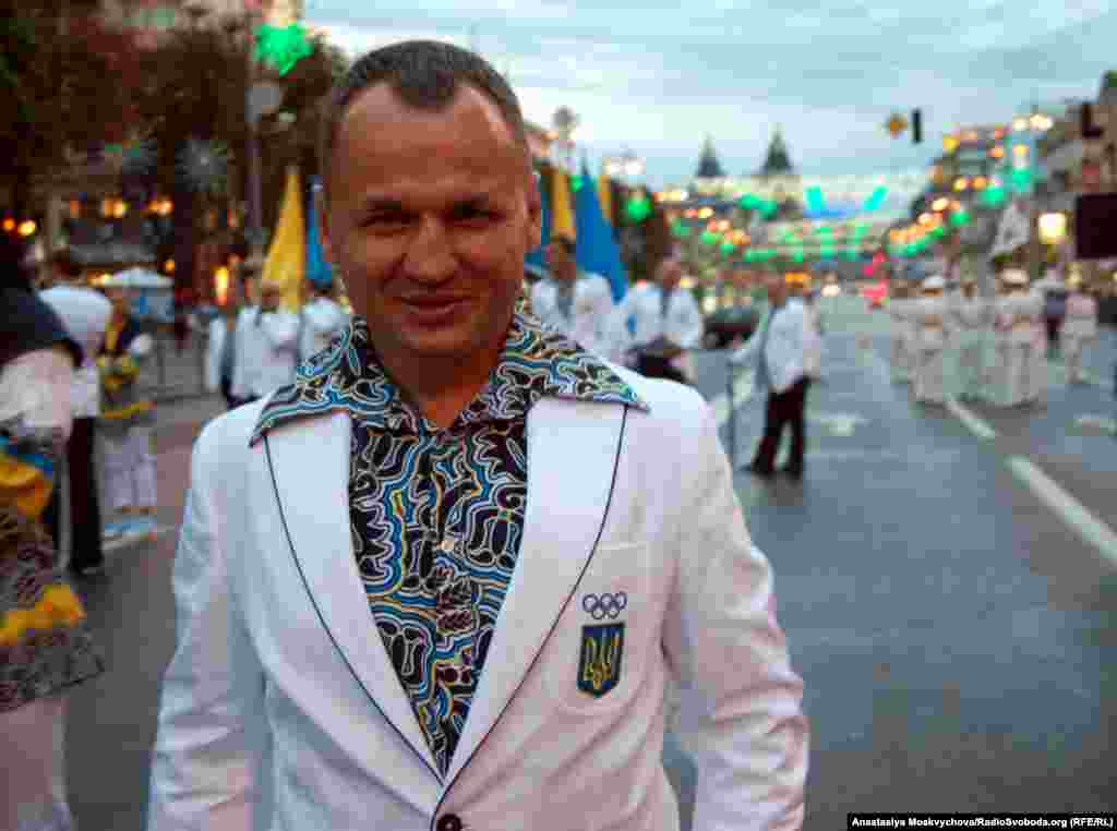 A Ukrainian athlete sports the team's dress uniform with a bold pattern and flared collar during a parade in Kyiv.