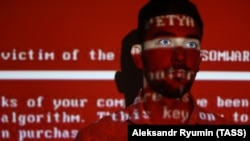 Russia -- A message related to the Petya ransomware is projected on a young man, Ryazan, 27 June 2017