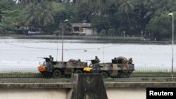 French armored personnel carriers cross General de Gaulle Bridge in Abidjan on April 5.