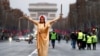 France - A woman dressed as Justice and French republic symbol "Marianne" poses during a demonstration by the "yellow vests" movement on the Champs Elysees near the Arc de Triomphe in Paris, France, December 22, 2018. 