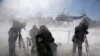 Reporters are whipped by snow as U.S. President Barack Obama departs via the Marine One helicopter from the White House. (Reuters/Jonathan Ernst)