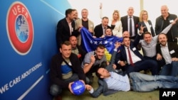 Delegation members from Kosovo celebrate their UEFA membership admission after the UEFA congress in Budapest on May 3.