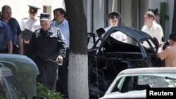 Moldovan security officers investigate the scene of the blast in Chisinau on June 7.