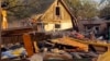 Houses lie in ruins after drone strikes on Ukraine's Sumy region that killed at least three people on October 22. 