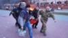 People carry an injured woman on a stretcher to an ambulance following a Russian air strike in Zaporizhzhya, Ukraine, on January 8.