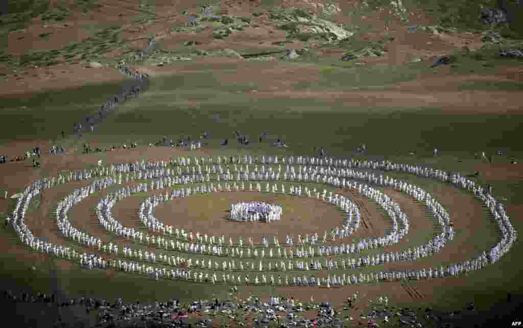 Members of an international religious movement called the White Brotherhood perform a ritual dance on the top of Rila Mountain, near Babreka Lake, Bulgaria. More than 1,500 pilgrims gathered to mark their "spiritual" new year with a collective meditative dance they believe connects them to cosmic rhythms and beats the blues. (AFP/Nikolay Doychinov)