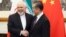 Chinese Foreign Minister Wang Yi (right) greets Iranian counterpart Mohammad Javad Zarif in Beijing on May 17. 