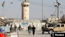 Afghan National Army soldiers and police keep watch outside the Bagram airfield entrance gate, after an explosion at the NATO air base, north of Kabul, on November 12.