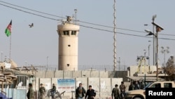 Afghan National Army soldiers and police keep watch outside the Bagram Airfield entrance gate. (file photo)