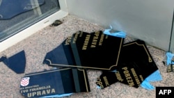 A sign with Serb Cyrillic script lies on the ground after being ripped off a wall by Croatian protesters in Vukovar on September 2.