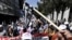 Demonstrators shout slogans near the Greek parliament building during a protest in Athens on May 4.