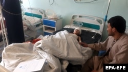 An Afghan boy who was reportedly injured in an air strike on a mosque in Takhar Province receives medical treatment at a local hospital on October 22.