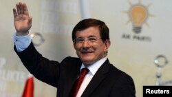 Turkey - Incoming Turkish prime minister Ahmet Davutoglu greets his supporters during the Extraordinary Congress of the ruling AK Party (AKP) to choose a new leader of the party in Ankara August 27, 2014