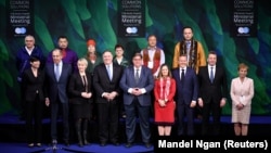 The foreign ministers pose for a picture during the Arctic Council summit in Rovaniemi on May 7.