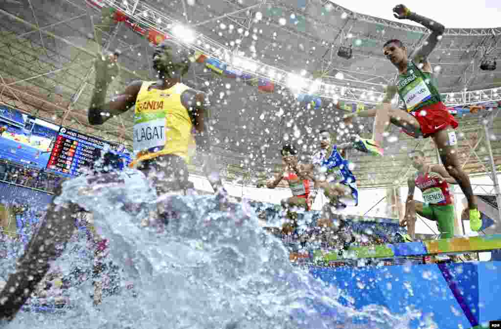 Athletes compete in the men&#39;s 3000-meter steeplechase event.