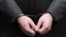 The handcuffed hands of Russian lawmaker Rauf Arashukov who was arrested this week on two counts of murder. 