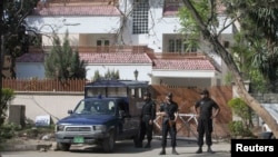 Policemen stand guard outside the house where Osama bin Laden's family is believed to have lived in Islamabad.