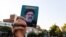 IRAN - A supporter of Iranian ultraconservative presidential candidate Ebrahim Raisi raises his portrait during a rally in the capital Tehran, on June 16, 2021