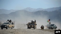 Afghan security forces patrol following an operation against Islamic State (IS) militants in Achin district in Nangarhar Province on February 17.