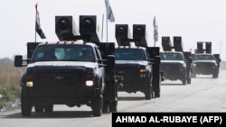 Iraqi forces drive towards Kurdish Peshmerga positions on October 14 on the southern outskirts of Kirkuk.