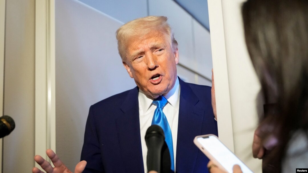 US President Donald Trump speaks to reporters on Air Force One. (file photo)
