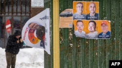 A man walks past election campaign posters in Greenland's capital, Nuuk, on March 8. 